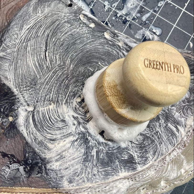 Close-up of a leather catcher's mitt being cleaned. 